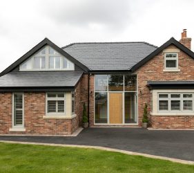 New Build Red Brick Property with Wood Style Timberlook Green Windows