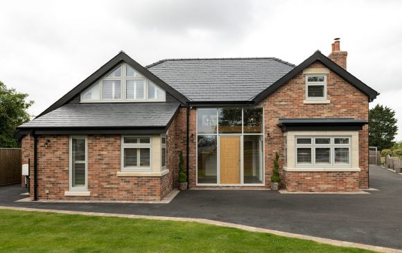 New Build Red Brick Property with Wood Style Timberlook Green Windows